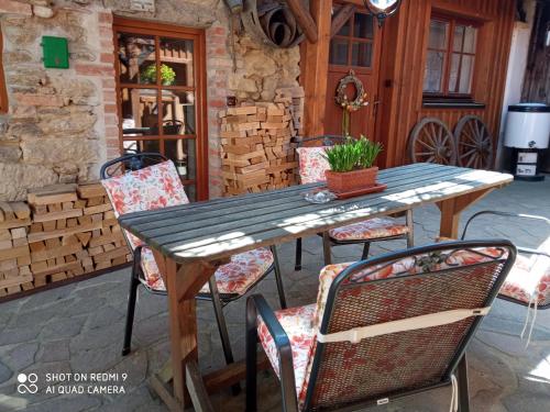 a wooden table and chairs on a patio at Pension Fanlor in Zubčická Lhotka