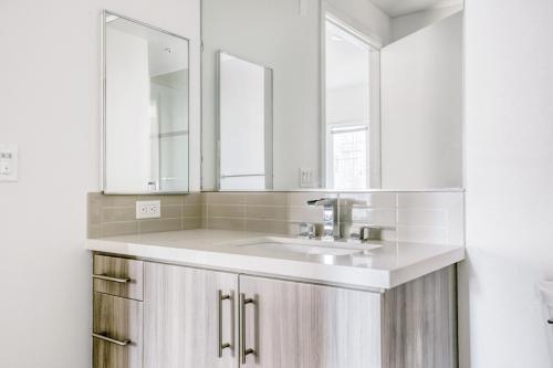 a white bathroom with a sink and two mirrors at Culver City 2br w gym lounge roof nr 405 LAX-1001 in Los Angeles