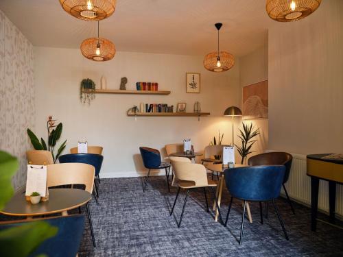 a dining room with tables and chairs and lights at Linton Lodge a BW Signature Collection Hotel in Oxford
