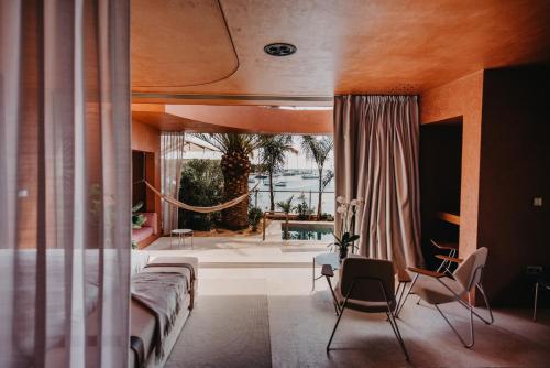 a bedroom with a bed and a view of a patio at Zori Timeless Hotel in Hvar