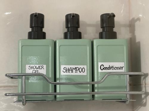 two bottles of soap sitting on a shelf at Charming central home in the heart of Budapest - Apartment Baby Loic in Budapest