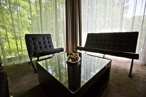 a living room with two chairs and a bowl of fruit at Platinum Palace Boutique Hotel & SPA in Wrocław