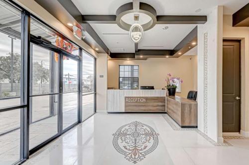an office lobby with a reception desk and large windows at Comfeeni Inn and Suites in Houston