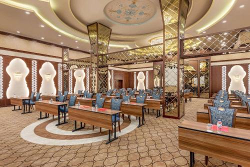 a restaurant with tables and chairs in a room at Ramada Plaza by Wyndham Silivri in Silivri