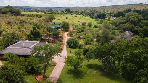 an aerial view of a house in a field at Baluleni Safari Lodge in Grietjie Nature Reserve