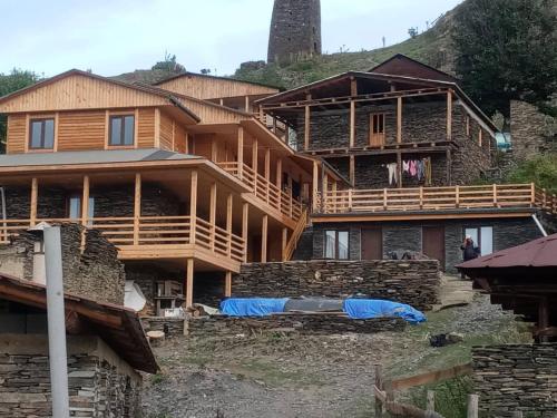 a large wooden house on top of a mountain at HOTEL AMIRAN in Tusheti