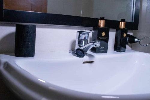 a bathroom sink with two bottles of coffee on it at Coqueto apartamento con vistas al mar in Denia