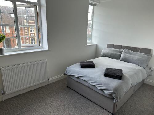 a bedroom with a bed with two pillows on it at Spectacular Modern, Brand-New, 1 Bed Flat, 15 Mins Away From Central London in Hendon