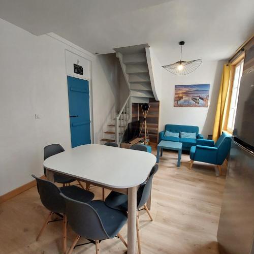 un salon avec une table et des chaises blanches dans l'établissement Le chant des mouettes a 300 m de la mer et du port, à Fécamp