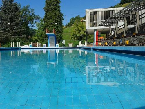 a large swimming pool with blue water at Romantic Cottage In Real Nature in Radeče