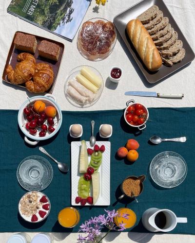 a table with bread and other food on it at Son de Mar Hotel rural & Apartamento in Quintueles