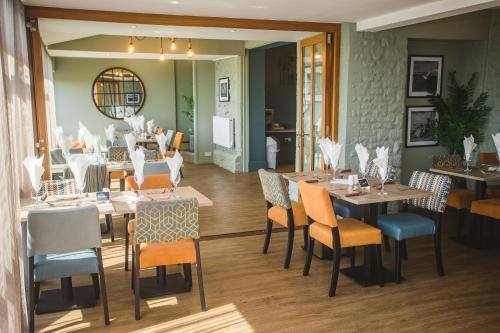 a dining room with wooden tables and chairs at Bells Hotel in Coleford