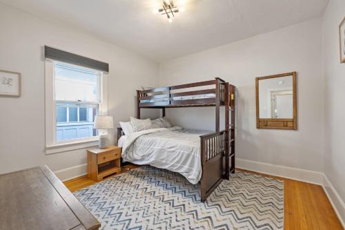 a bedroom with a bunk bed and a mirror at 2 Bedroom Near Trolley Square and Liberty Park! in Salt Lake City