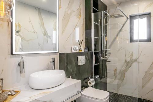 a bathroom with a shower and a toilet and a sink at EcoStay - Infinity business class 2BDR apartment by the sea in Alimos in Athens