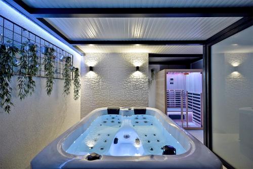a large bath tub in a bathroom with a window at Art Spa Zeus in Pula