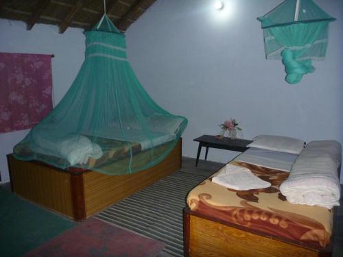 Postel nebo postele na pokoji v ubytování Bardia Jungle Cottage