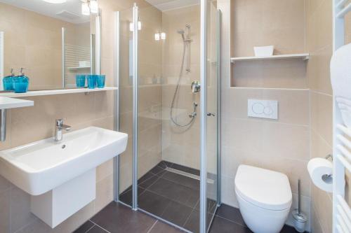a bathroom with a shower and a sink and a toilet at John Silver in Norderney