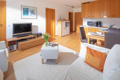 a living room with a couch and a television at Kleine Möwe 11 in Norderney