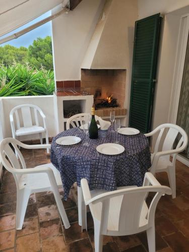 a dining room with a table and chairs and a fireplace at Apartamento Gecko in Son Parc
