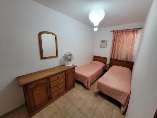 a bedroom with two beds and a mirror at Apartamento Gecko in Son Parc
