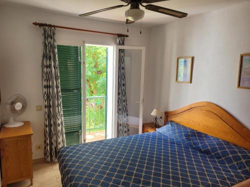 a bedroom with a bed with a blue checkered blanket at Apartamento Gecko in Son Parc