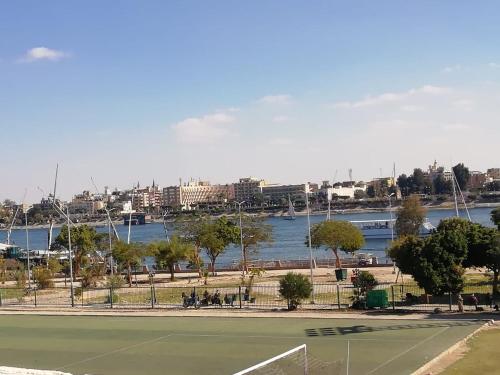 a tennis court next to a body of water at Nile Roof Hotel& Restaurant in Luxor