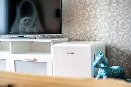 a toy horse is sitting next to a television at Hotel Fontána in Brno