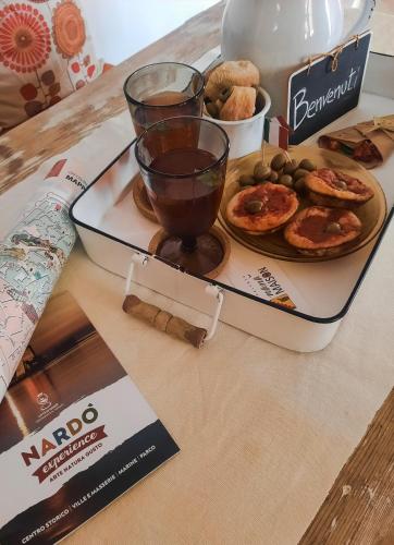 a tray of food on a table with a drink at Nanà Maison in Nardò