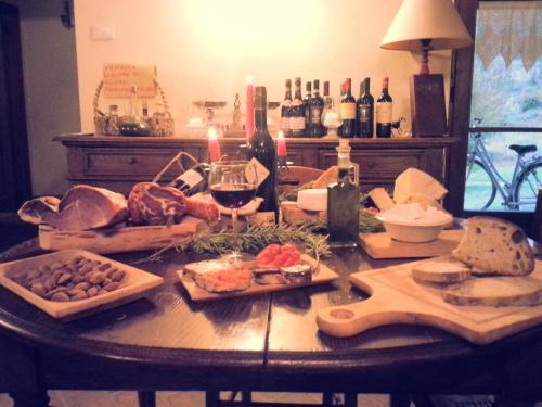 a table with food and wine on top of it at Agriturismo Santa Giusta in Poggio San Lorenzo