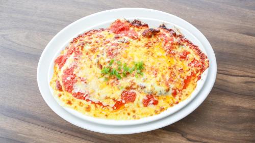 a pizza on a white plate on a table at Chalé das Águas in Igaratá