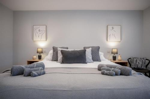 a bedroom with a large bed with pillows on it at The Barn At Kiln Park - 2 Bed Cottage - Narberth in Narberth