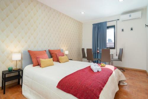 a bedroom with a large bed with a red blanket at Magnificent Sunny Flat - Douro River in Vila Nova de Gaia