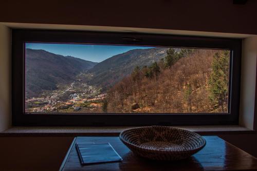 a large window with a view of a mountain at Casa Terraços do Lobo in Manteigas
