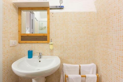 a bathroom with a sink and a mirror at Charming Old Town House in Bari