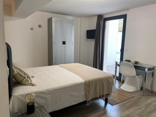 1 dormitorio con cama, escritorio y ventana en Studio AVEC TERRASSE Carry le Rouet, en Carry-le-Rouet