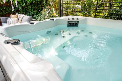 a jacuzzi tub with blue water in a yard at Newmarket Boutique Apartments in Newmarket