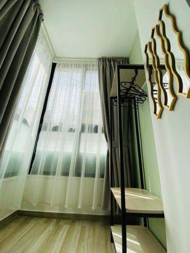 a living room with a large window and a chair at Arabesque Hotel in Amman
