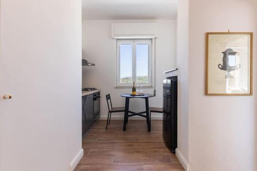 a kitchen with a table and a window at Mansarda Aurispa in Noto