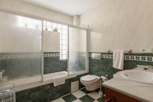 a bathroom with a toilet and a sink and a shower at Los Boliches apartment near the beach Ref 122 in Fuengirola