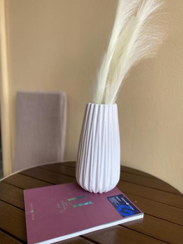 a vase sitting on top of a book on a table at Hotel Areti in Aegina Town
