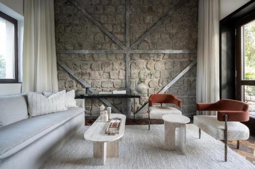 a living room with a couch and two chairs at Pereh Mountain Resort in Gadot