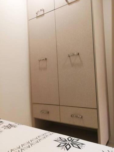 a bedroom with white cabinets and a white bed at Adria Residences - Emerald Garden - 2 Bedroom Unit for 4 person in Manila
