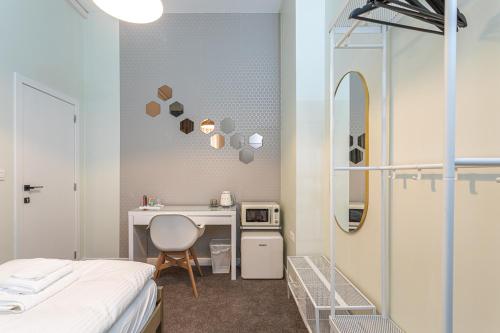 Habitación con cama, escritorio y espejo. en Studio Anvers, en Amberes