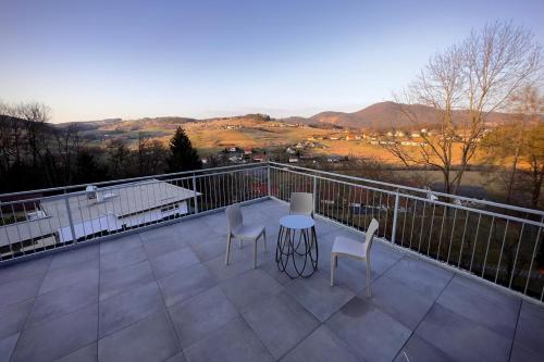 a patio with a table and chairs on a balcony at Trautes Quartier in Bad Gleichenberg