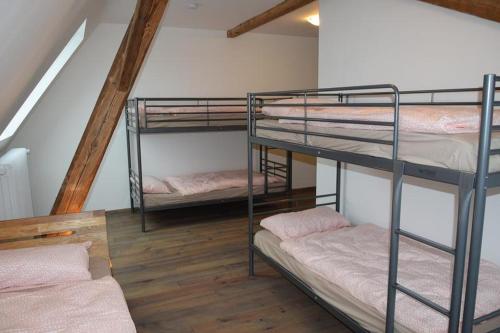a room with three bunk beds in a room at Altes Pastorat in Kevelaer