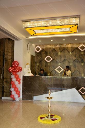 a lobby with a cross in the middle of a room at Hotel Ramaya in Gwalior