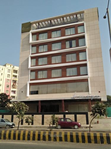 a building with a red car parked in front of it at Hotel Ramaya in Gwalior