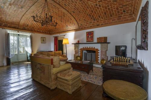 a living room with a couch and a fireplace at Quinta de Santa Barbara by Heavens Sleepy in Constância