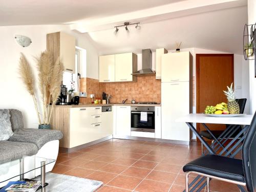 a kitchen and living room with a couch and a table at Apartment Lady Daniela mit Meerblick in Lovran in Lovran