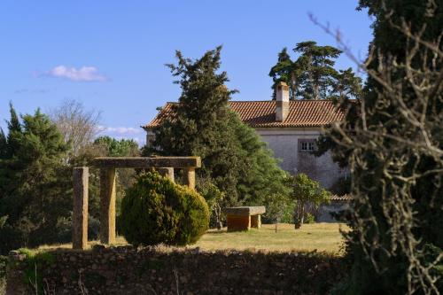 a house in the background with a garden and a building at Quinta de Santa Barbara by Heavens Sleepy in Constância